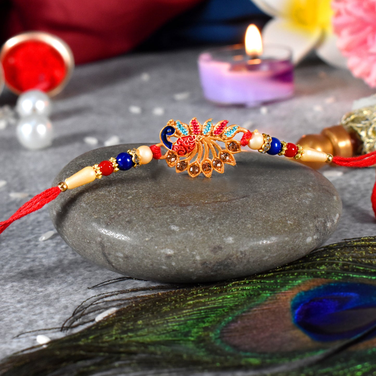 Colorful Peacock Rakhi With Stone Detailing And Red Thread