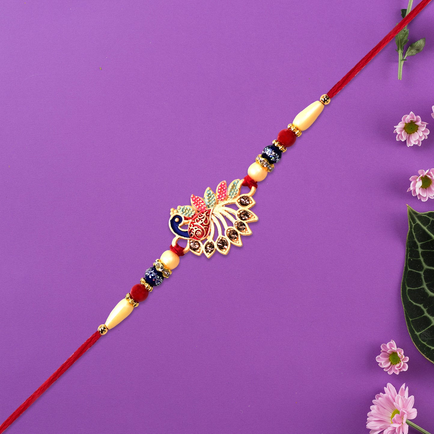 Colorful Peacock Rakhi With Stone Detailing And Red Thread
